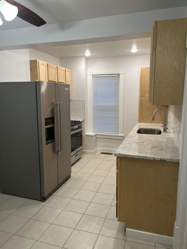 351 Morse Ave, Excelsior, MN 55331 - kitchen with stainless steel appliances, a sink, light brown cabinetry, tasteful backsplash, and light tile patterned flooring