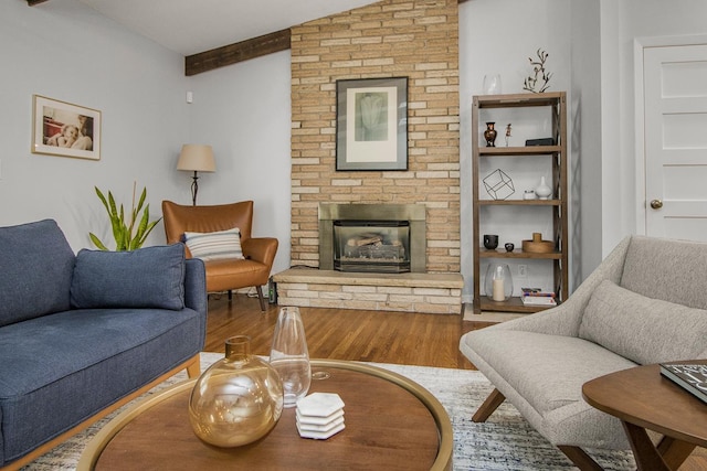 living room with a brick fireplace, hardwood / wood-style flooring, and lofted ceiling