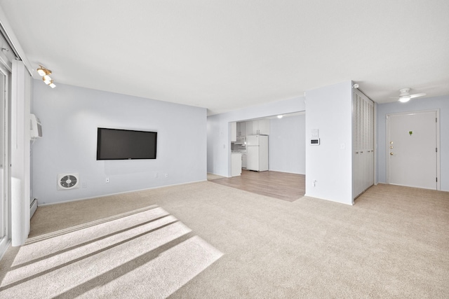 unfurnished living room featuring light carpet