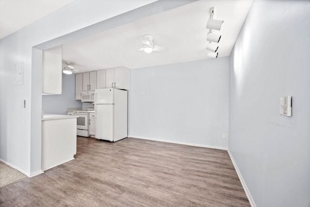 kitchen with light hardwood / wood-style flooring, rail lighting, white appliances, white cabinets, and ceiling fan