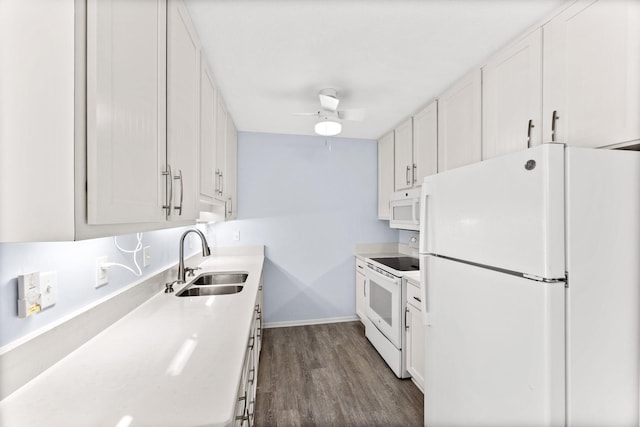 kitchen featuring sink, white appliances, white cabinetry, and dark wood-type flooring