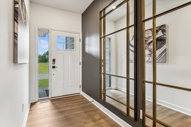 foyer entrance with hardwood / wood-style floors