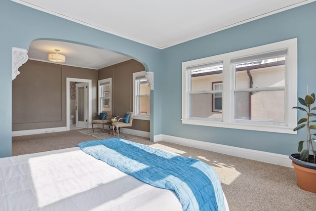 1625 25th St, Minneapolis, MN 55405 - carpeted bedroom with arched walkways, ornamental molding, and baseboards