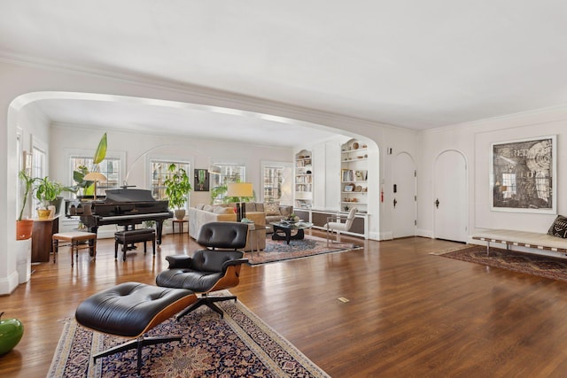 1625 25th St, Minneapolis, MN 55405 - living room featuring arched walkways, wood finished floors, plenty of natural light, and ornamental molding