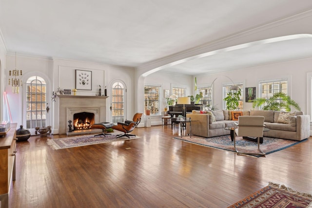 1625 25th St, Minneapolis, MN 55405 - living area featuring arched walkways, plenty of natural light, wood finished floors, and ornamental molding