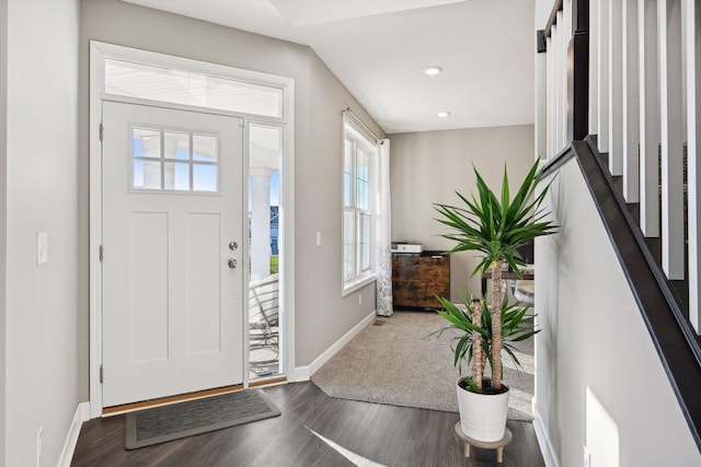 entryway with dark hardwood / wood-style flooring and a barn door