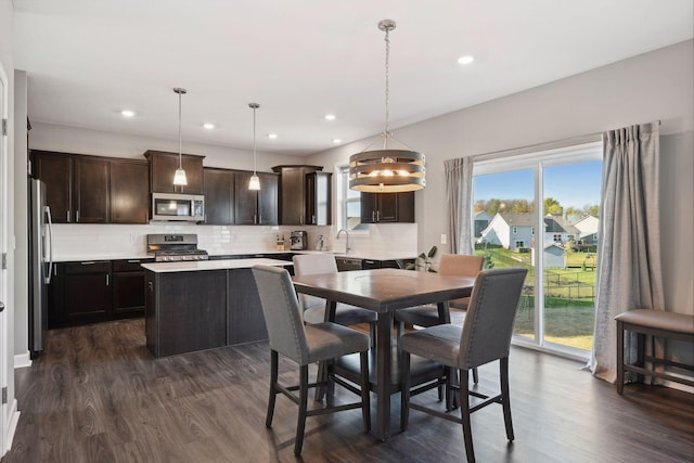 dining area featuring sink and dark hardwood / wood-style floors