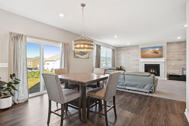 dining room with a fireplace and dark wood-type flooring