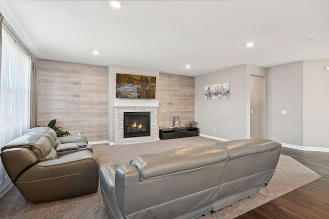 living room with a fireplace and dark wood-type flooring