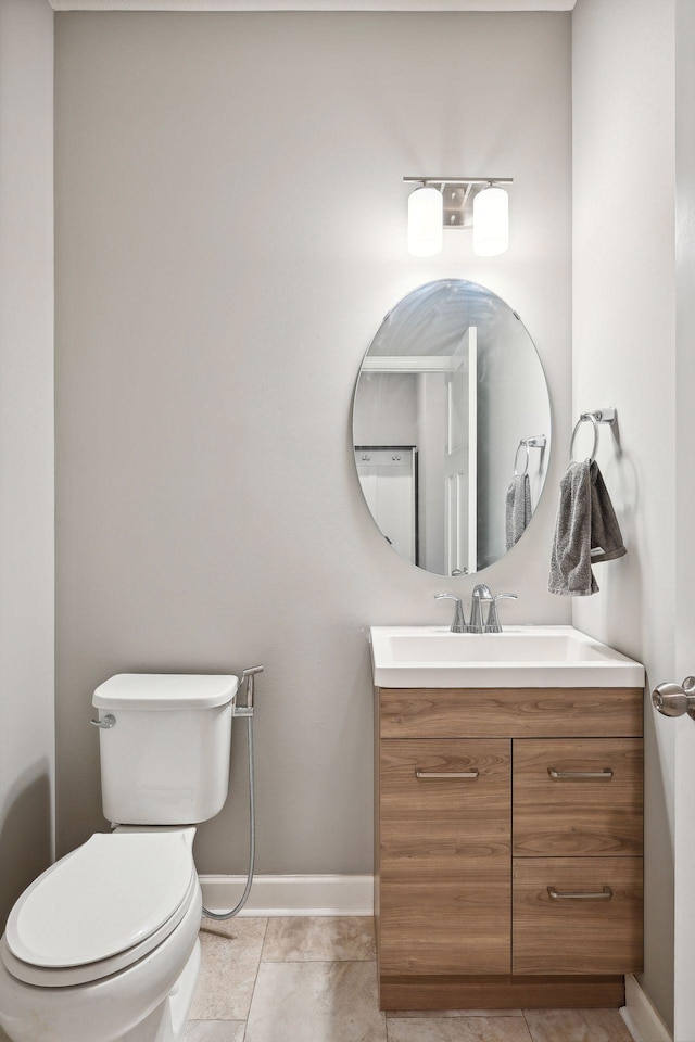 bathroom featuring vanity, toilet, and tile patterned floors