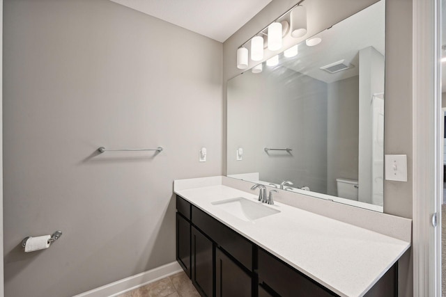 bathroom with vanity, tile patterned flooring, and toilet