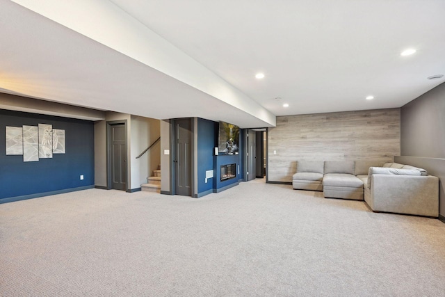 unfurnished room featuring carpet floors and wood walls