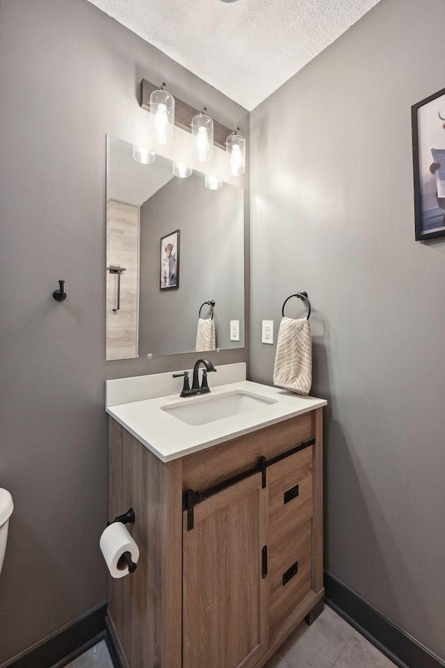 bathroom with vanity, tile patterned flooring, and a textured ceiling