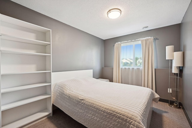 carpeted bedroom with a textured ceiling