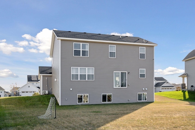 back of house featuring a lawn