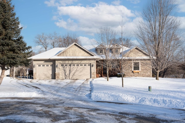 view of front of home featuring stone siding and an attached garage