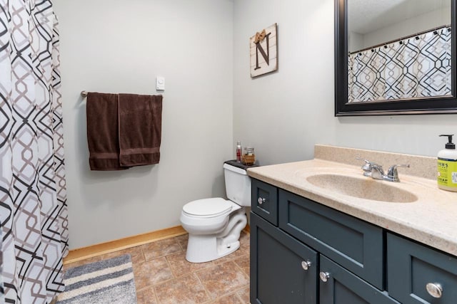 bathroom with toilet and vanity