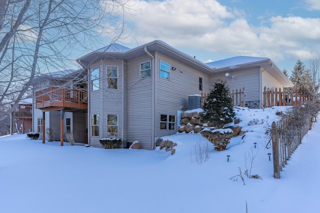 view of snow covered exterior featuring a wooden deck