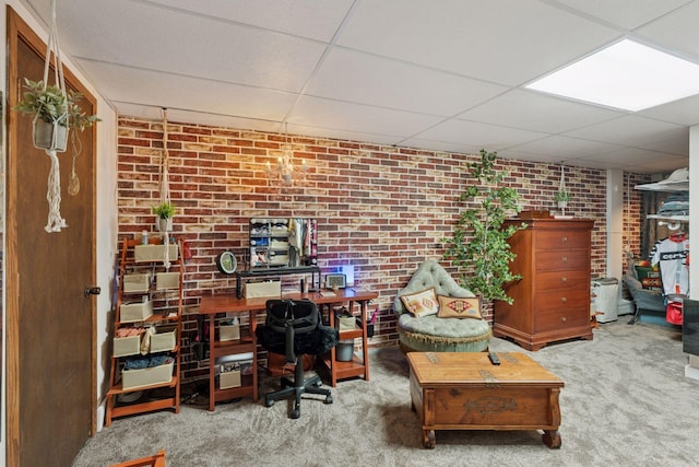 office with brick wall, carpet, and a drop ceiling