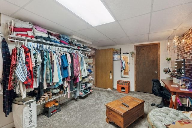 walk in closet with carpet and a drop ceiling