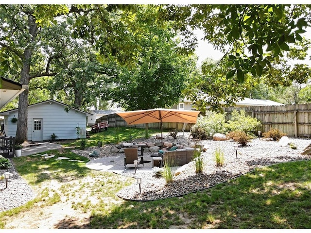 view of yard featuring a patio area, outdoor lounge area, and fence