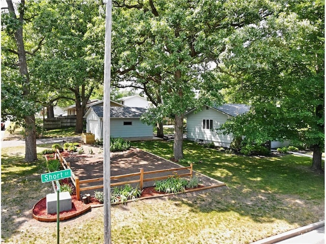 view of yard with an outdoor structure and fence