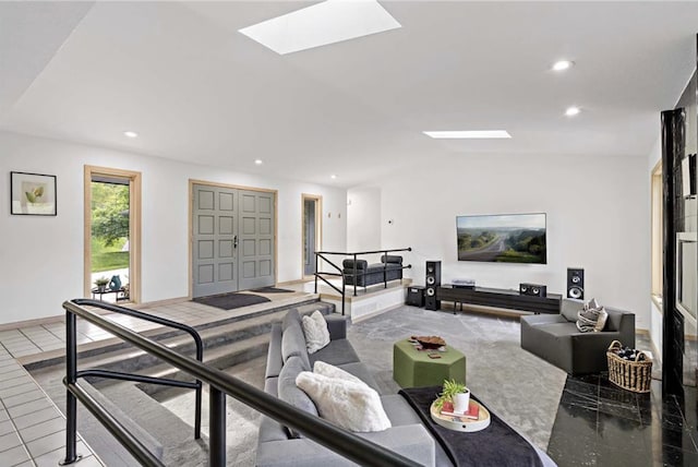 living area with recessed lighting and vaulted ceiling with skylight