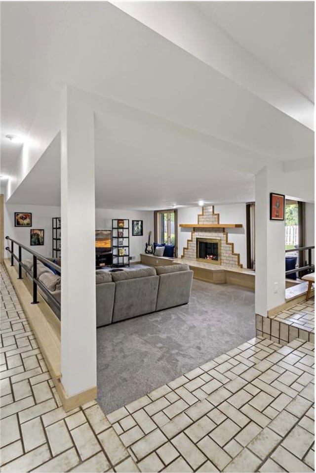 living room with light carpet and a brick fireplace