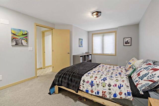 bedroom with baseboards and carpet floors