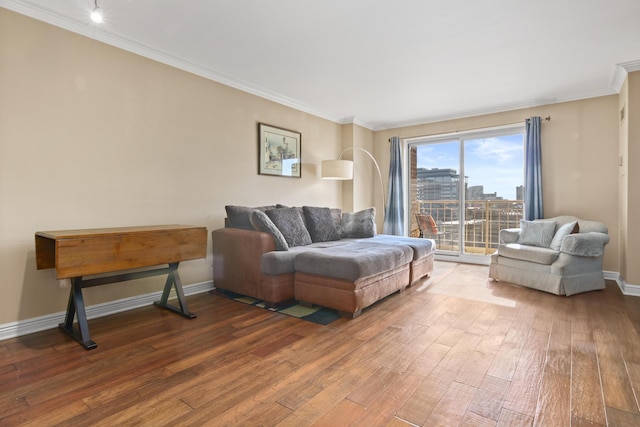 living room with a view of city, ornamental molding, wood-type flooring, and baseboards