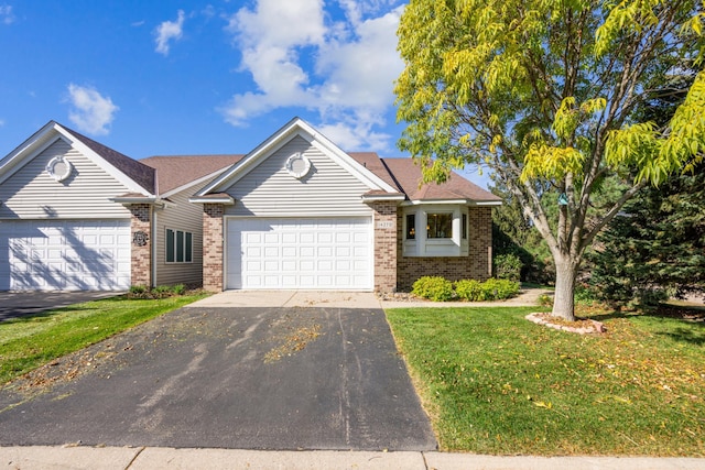 view of front of house with a front lawn and a garage