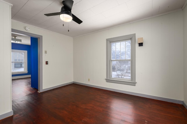 unfurnished room with crown molding, dark hardwood / wood-style floors, and ceiling fan