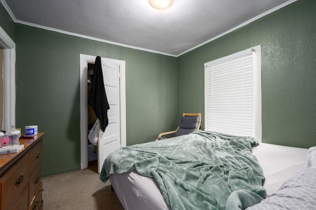 carpeted bedroom featuring a textured ceiling and ornamental molding