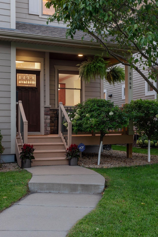 doorway to property featuring a shingled roof