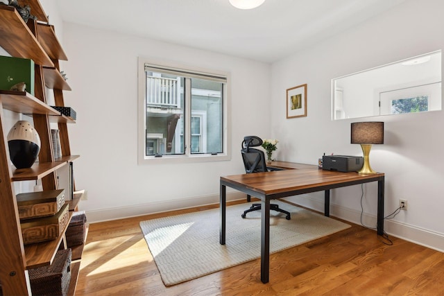 home office with wood finished floors and baseboards