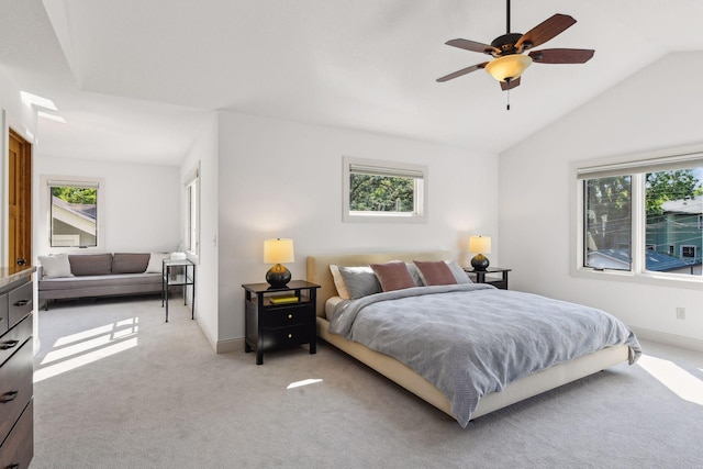 bedroom featuring light carpet, multiple windows, and vaulted ceiling