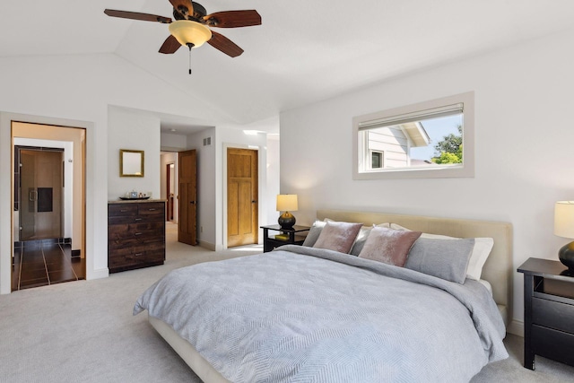 bedroom featuring lofted ceiling, ceiling fan, visible vents, and carpet flooring