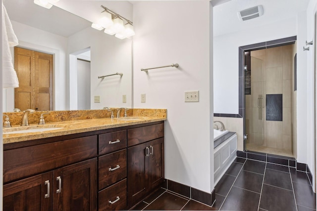 bathroom with a sink, a shower stall, a bath, and tile patterned floors