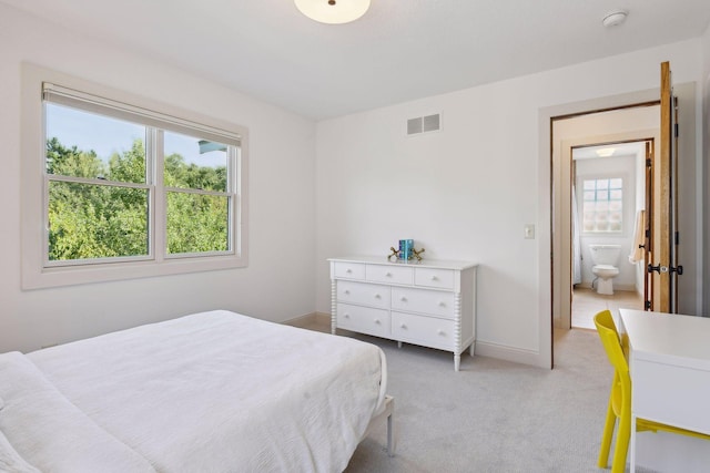 bedroom featuring light carpet, baseboards, and visible vents