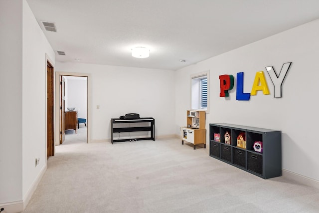 sitting room featuring carpet, visible vents, and baseboards