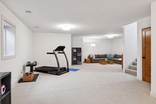 exercise room with carpet floors and baseboards