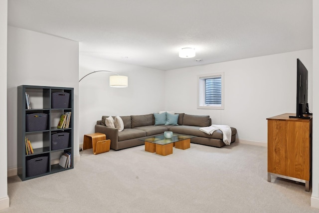 carpeted living area featuring baseboards