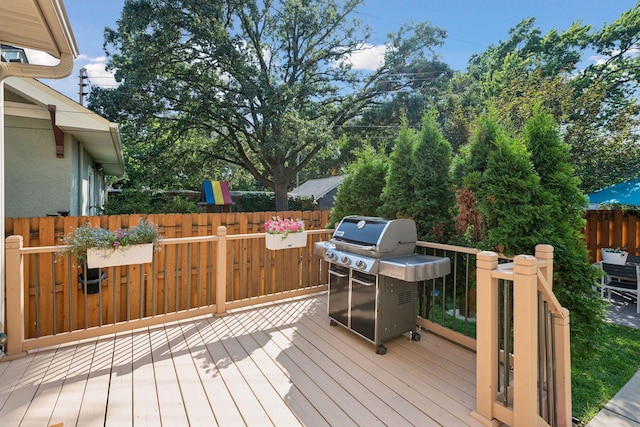 wooden deck with fence and area for grilling