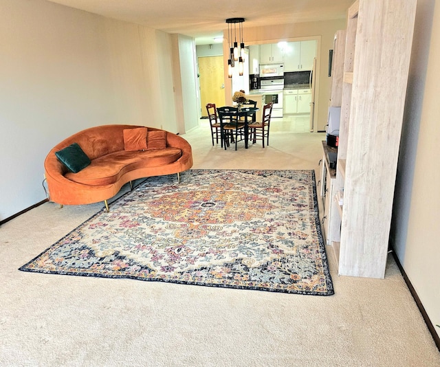 living room with baseboards and light colored carpet