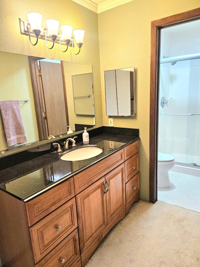 full bath with toilet, a shower stall, vanity, and crown molding