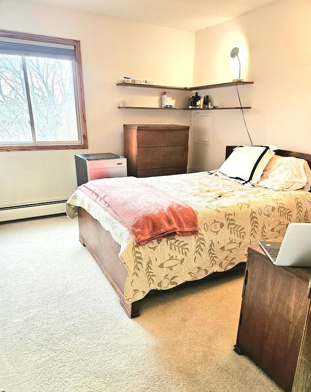 bedroom featuring light carpet and a baseboard radiator