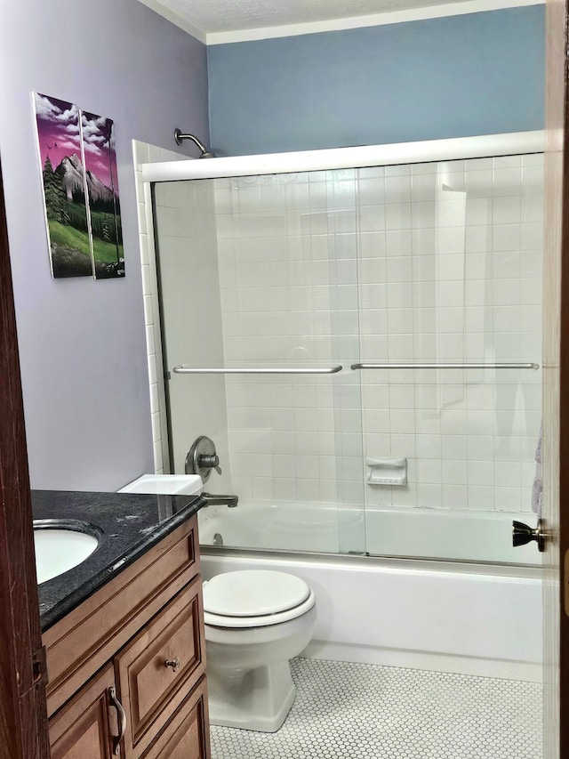 bathroom with toilet, tile patterned floors, enclosed tub / shower combo, and vanity