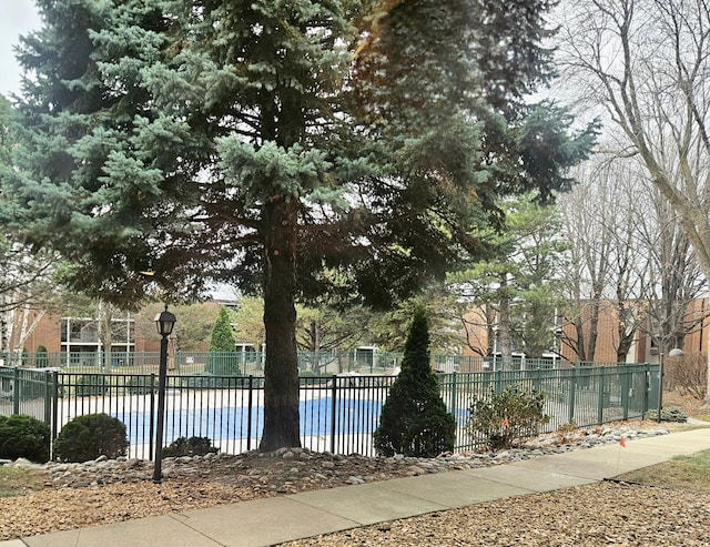 view of pool featuring a swimming pool and fence