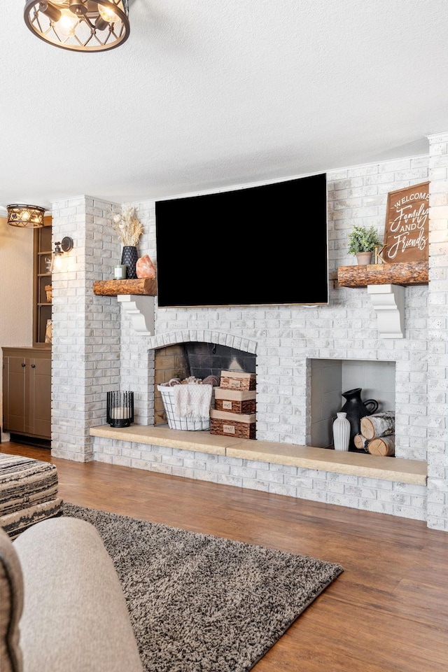 living area featuring a textured ceiling and wood finished floors