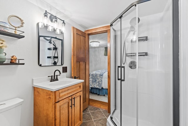 bathroom featuring tile patterned floors, a stall shower, vanity, and ensuite bathroom